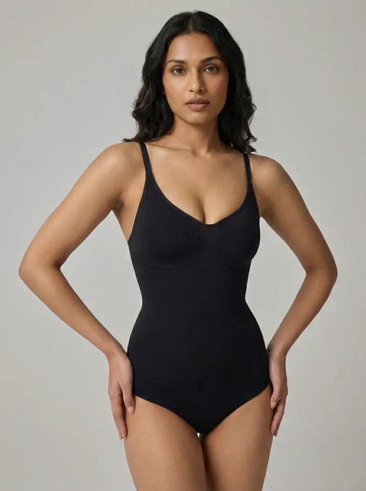 Woman wearing a black one-piece swimsuit against a gray background