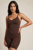Woman wearing a brown bodysuit against a beige background