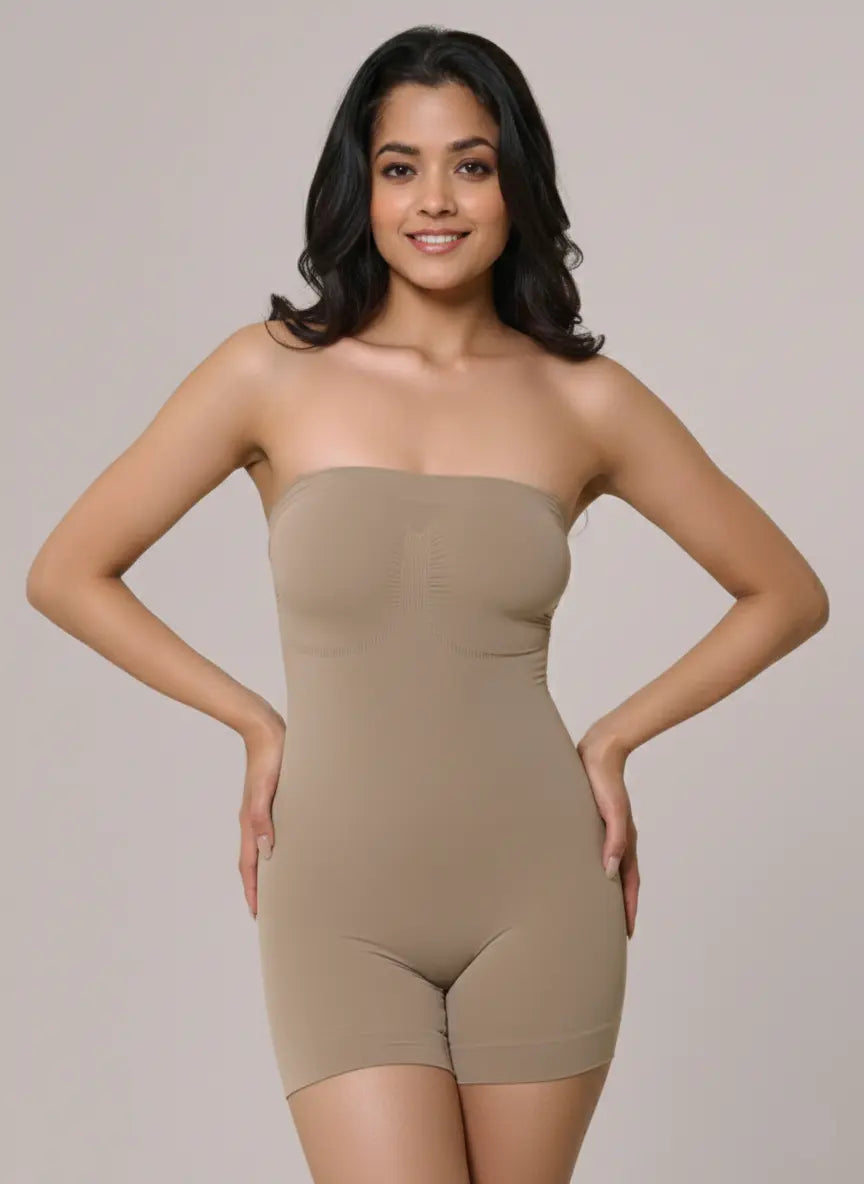Woman wearing a beige strapless bodysuit against a plain background